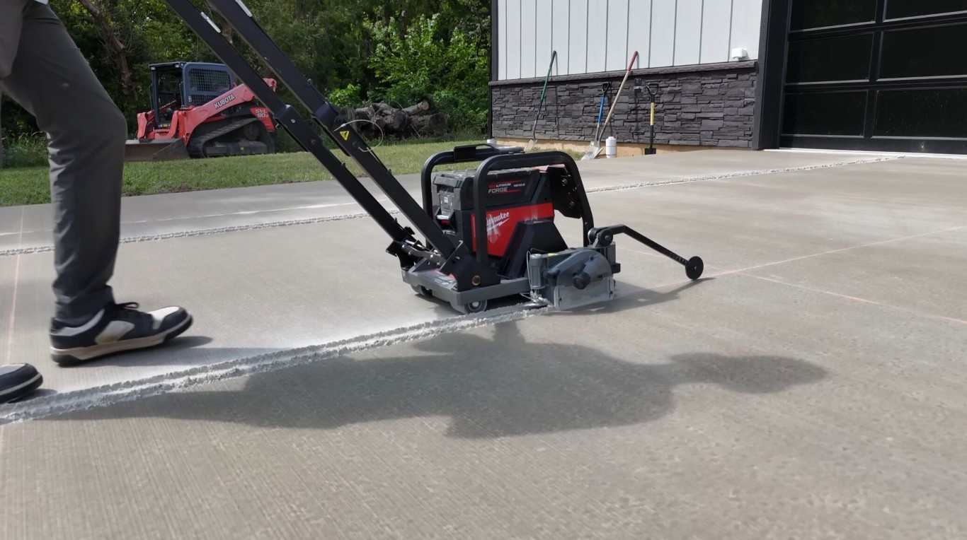 Professional concrete driveway installation with power finishing equipment in Leavenworth, KS